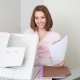 Smiling business woman operating photocopy machine in office