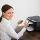 Young Happy Businesswoman Using Mobile Phone For Printing Graph Paper