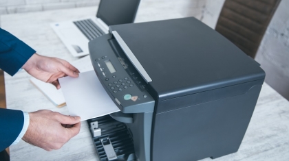 man working in xerox device in office